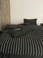 Black striped bedding set from Breezora featuring a stylish pattern on soft, comfortable linens for a modern bedroom look.