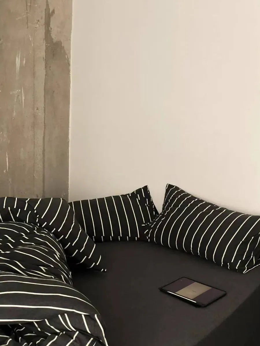 Black striped bedding set by Breezora featuring a cozy, stylish design with matching pillowcases and a smooth fabric finish.