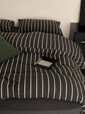 Black striped bedding set by Breezora featuring a cozy, stylish design with a soft fabric finish.
