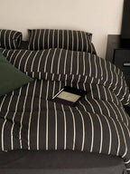 Black striped bedding set by Breezora featuring a cozy, stylish design with a soft fabric finish.