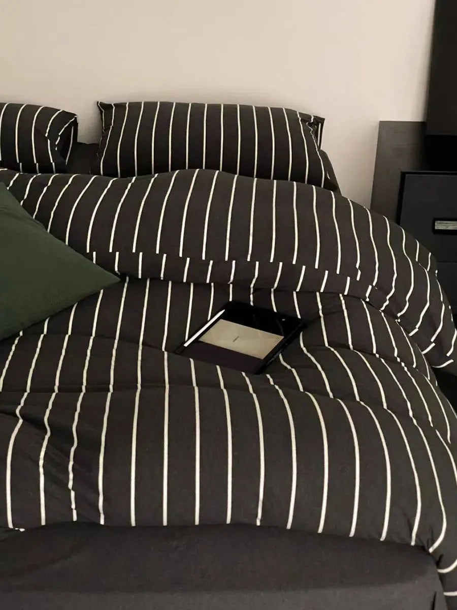 Black striped bedding set by Breezora featuring a cozy, stylish design with a soft fabric finish.