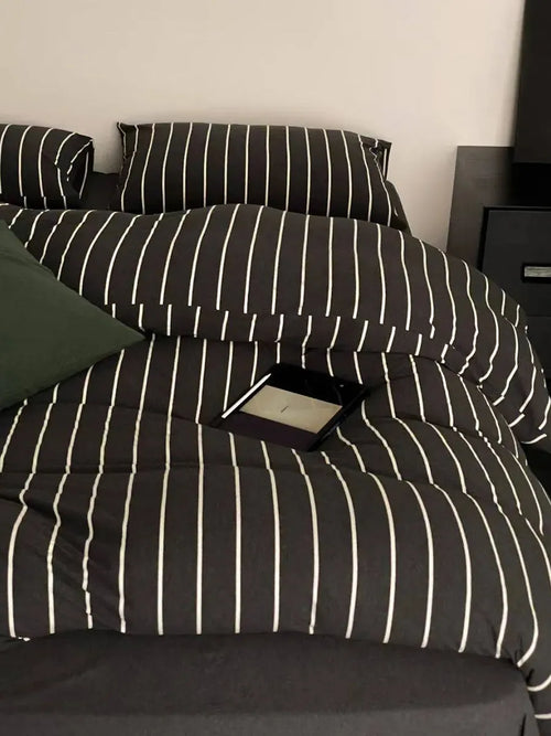 Black striped bedding set by Breezora featuring a cozy, stylish design with a soft fabric finish.