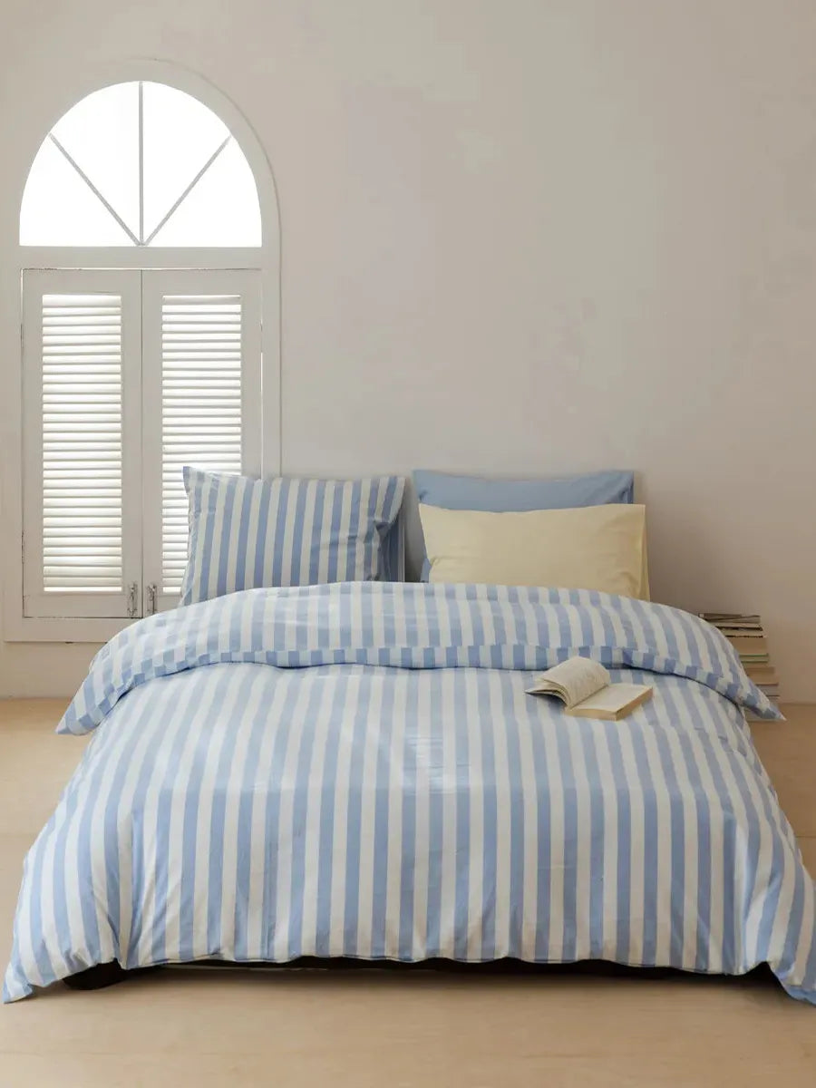 Breezora mixed blue striped bedding set featuring a vibrant pattern with matching pillowcases and duvet cover.