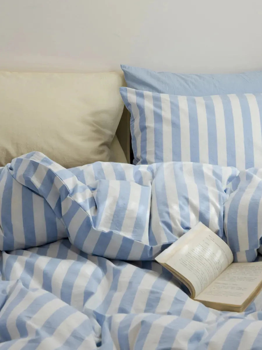Mixed blue striped bedding set by Breezora featuring a stylish design with coordinating pillowcases and duvet cover.