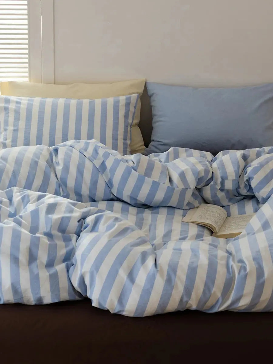 Breezora mixed blue striped bedding set featuring a stylish design with various shades of blue and white stripes.