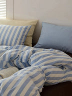 Mixed blue striped bedding set by Breezora, featuring a stylish design with various blue tones and textures.