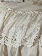 Boho linen lace bedding set by Breezora featuring intricate lace details and a soft, textured finish in neutral tones.
