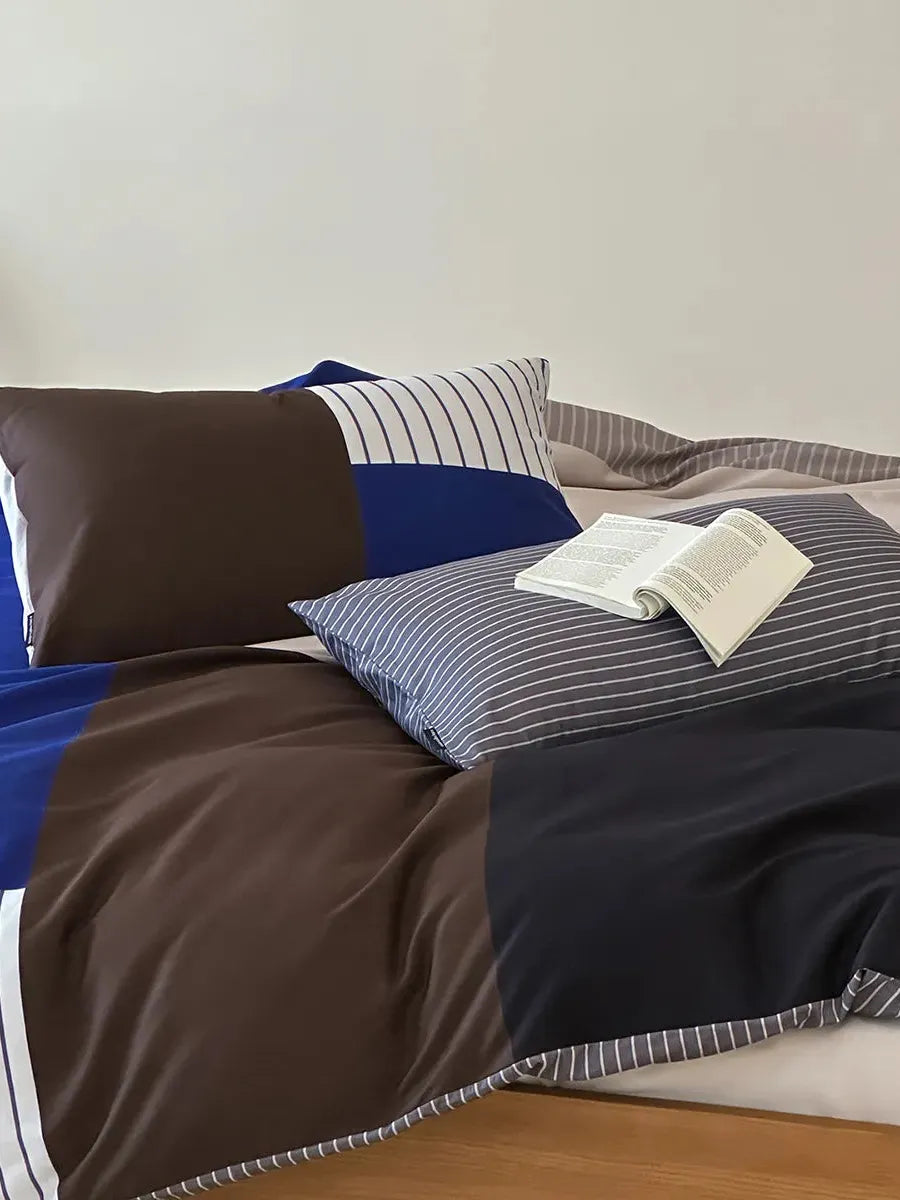 Breezora contrast striped bedding set featuring bold stripes and a cozy design in a neatly arranged bedroom setting.