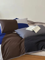 Breezora contrast striped bedding set featuring bold stripes and a cozy design in a neatly arranged bedroom setting.