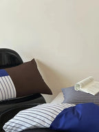 Breezora contrast striped bedding set featuring bold stripes and soft fabric in a neatly arranged design on a bed.