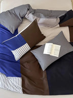 Contrast striped bedding set by Breezora featuring bold stripes and soft fabric in a cozy bedroom setting.