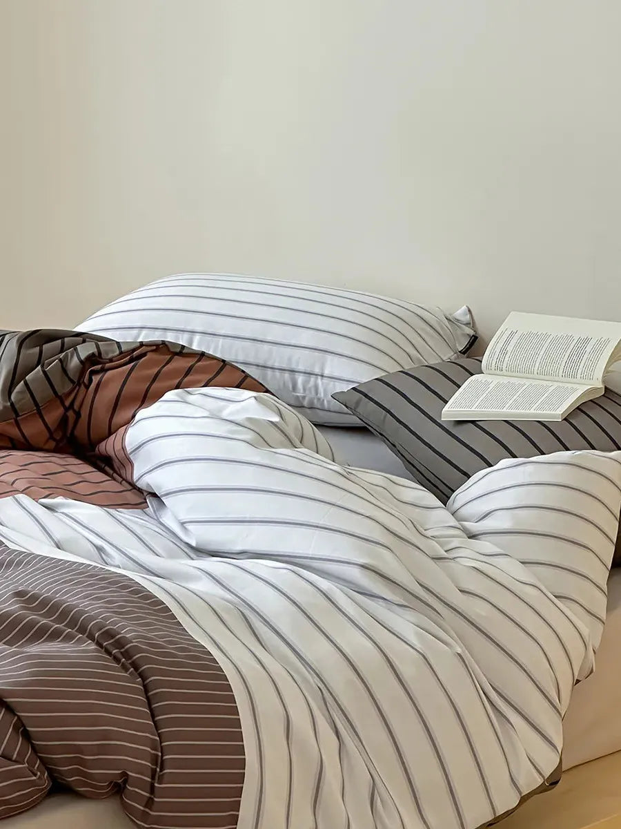 Breezora contrast striped bedding set featuring bold stripes and soft fabric in a stylish arrangement on a bed.