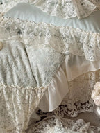 Breezora Rococo layered lace bedding set featuring intricate lace patterns and soft fabric in a serene bedroom setting.
