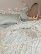 Breezora Rococo layered lace bedding set featuring intricate lace details and soft pastel colors on a plush bed.