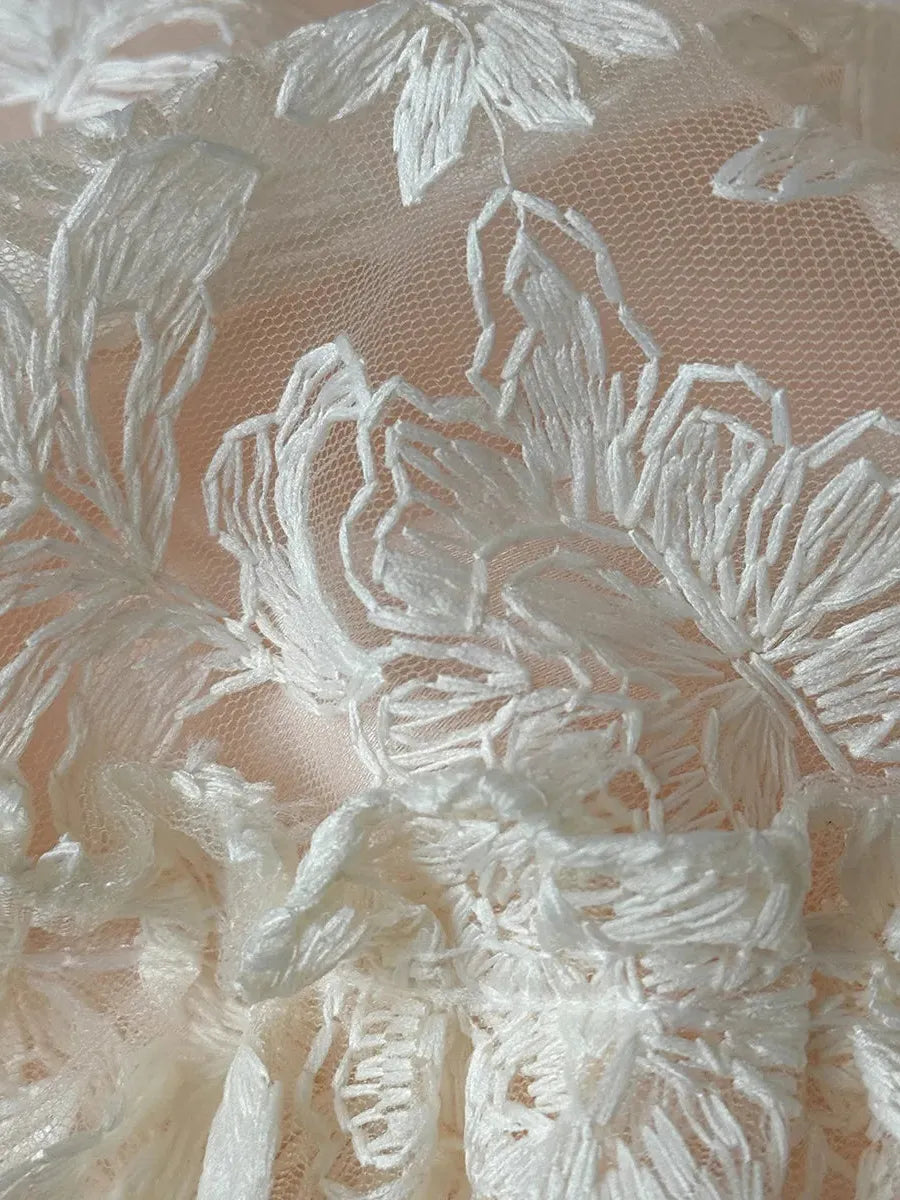 Breezora Rococo layered lace bedding set featuring intricate lace details and soft, textured fabrics in a cozy bedroom setting.
