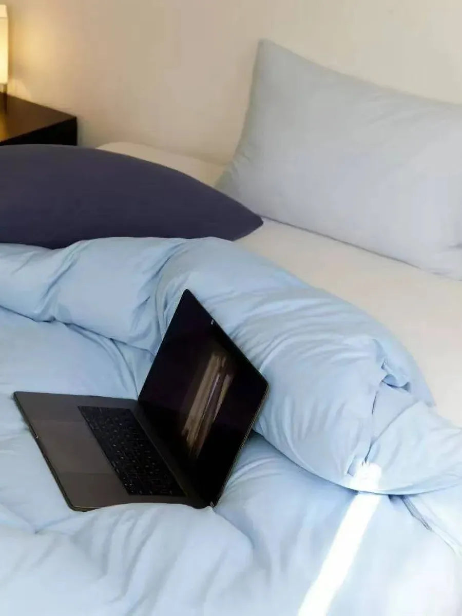 Colorful Breezora mixed color bedding set with patterned duvet cover and matching pillowcases on a bed.