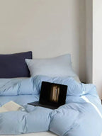 Breezora mixed color bedding set with matching pillowcases and duvet cover, vibrant and soft fabric for a cozy bedroom look.