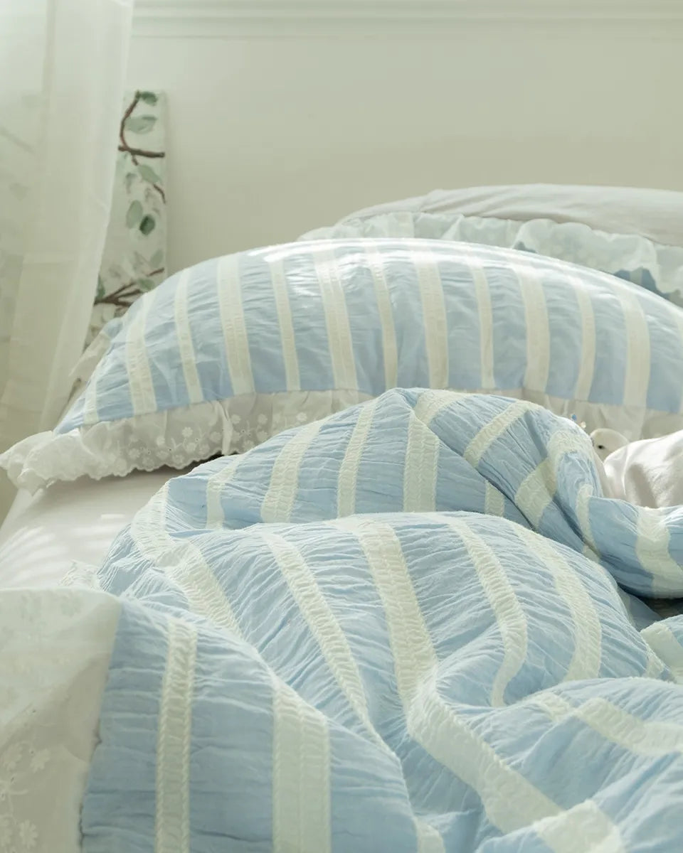 Striped jacquard bedding set by Breezora featuring a delicate lace ruffle accent on the edges.