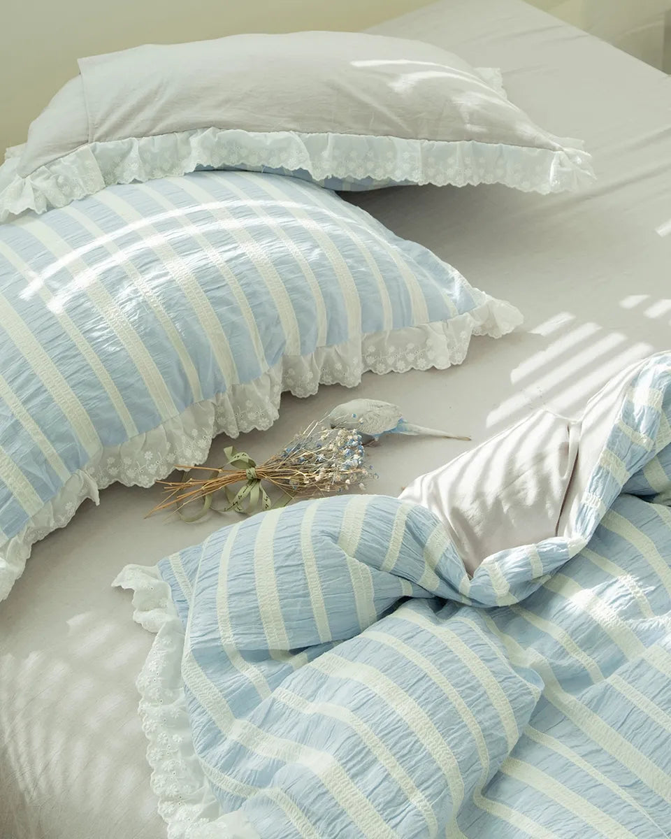 Breezora striped jacquard bedding set featuring intricate lace ruffle details on a soft fabric background.