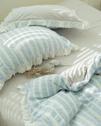 Breezora striped jacquard bedding set featuring intricate lace ruffle details on a soft fabric background.