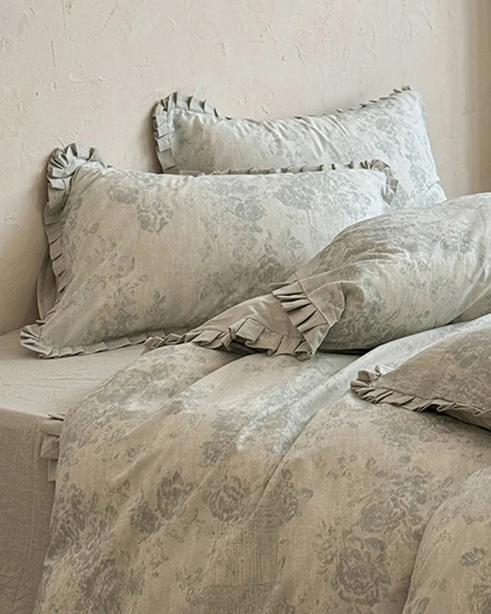 Vintage floral bedding set by Breezora featuring intricate patterns and soft fabric in a cozy bedroom setting.