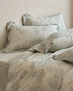 Vintage floral bedding set by Breezora featuring intricate patterns and soft fabric in a cozy bedroom setting.