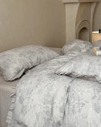 Breezora vintage floral bedding set featuring a delicate flower pattern on soft fabric with coordinating pillowcases.