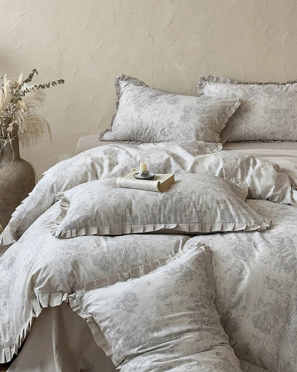 Vintage floral bedding set by Breezora featuring intricate patterns and soft colors on a cozy bed arrangement.