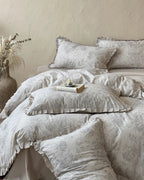 Vintage floral bedding set by Breezora featuring intricate patterns and soft colors on a cozy bed arrangement.