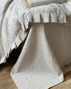 Breezora vintage floral bedding set featuring delicate flowers on soft fabric, styled with matching pillowcases and comforter.