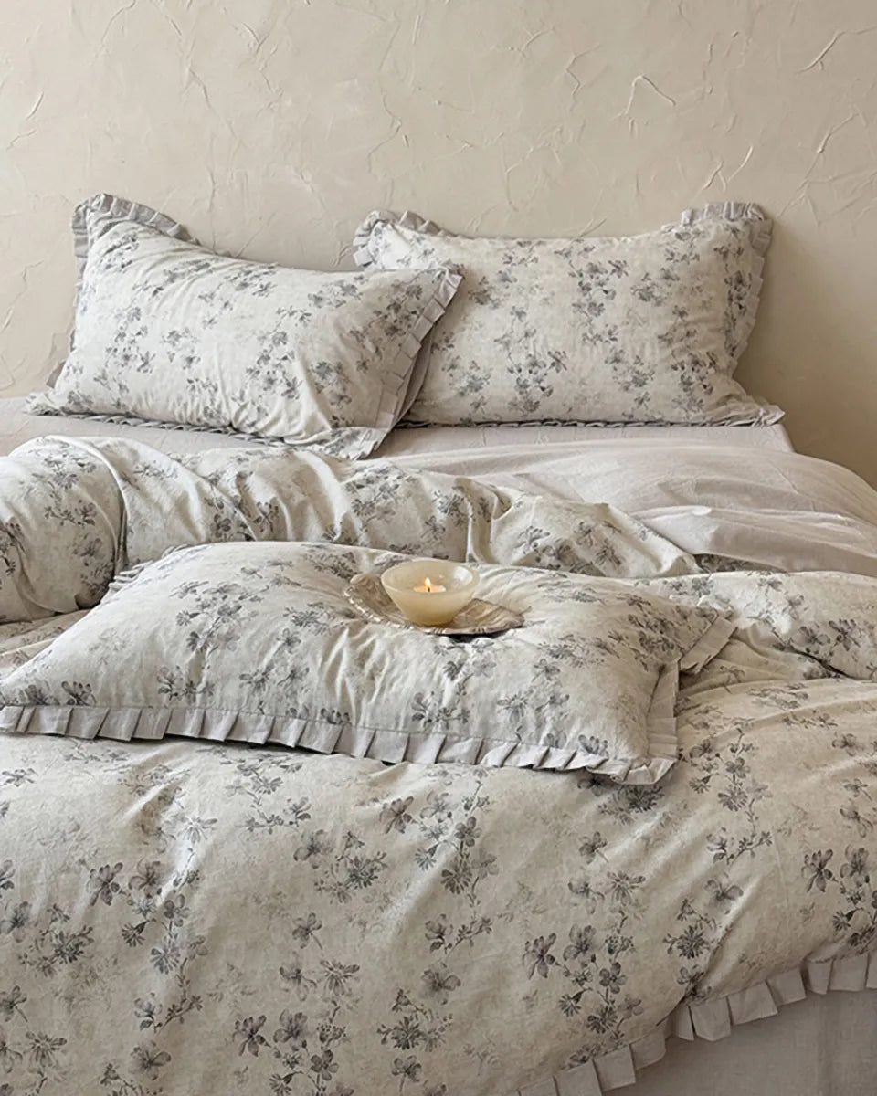 Vintage floral bedding set by Breezora featuring colorful flowers on a soft fabric, styled on a neatly made bed.